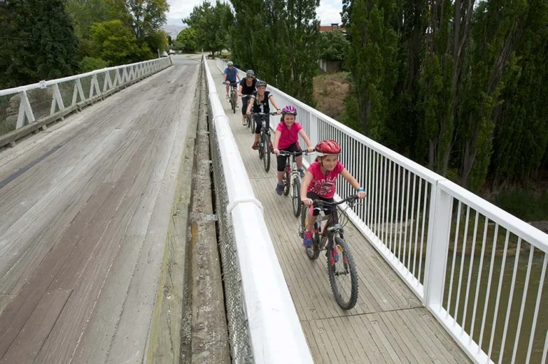 Family cycling over a bridge near Naseby