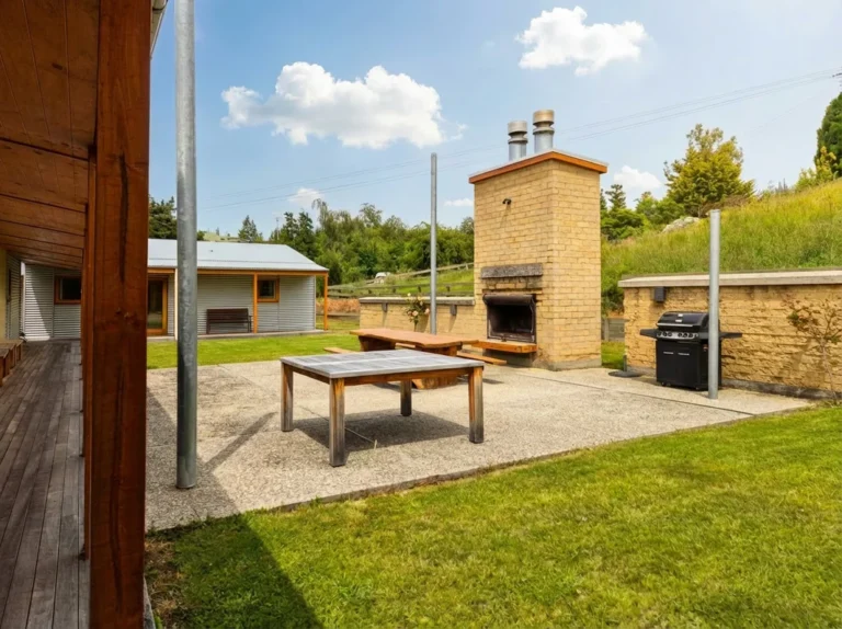 Outdoor fireplace and grill area with seating